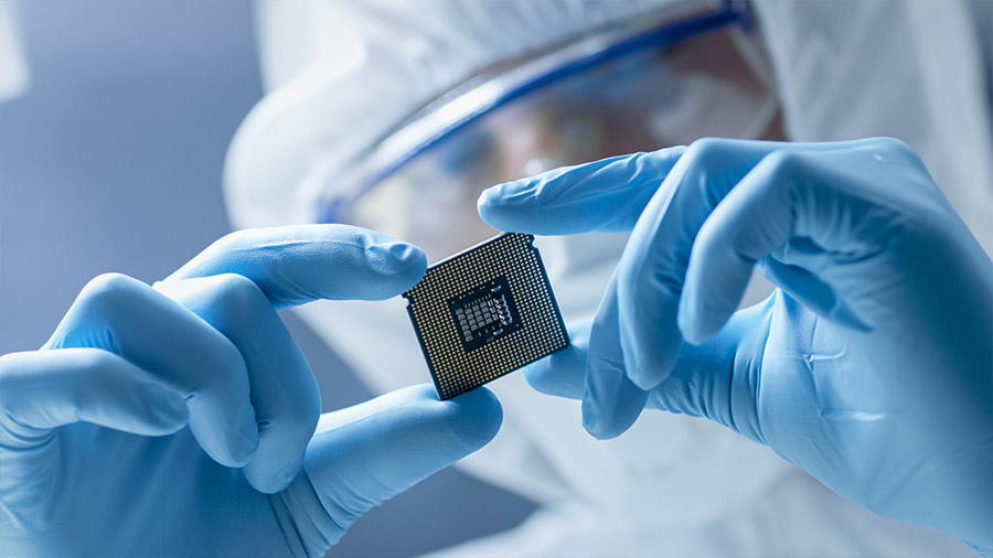 An engineering holding a semiconductor chip