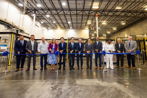 Attendees_participate_in_a_ribbon-cutting_ceremony_to_celebrate_the_completion_of_the_facility